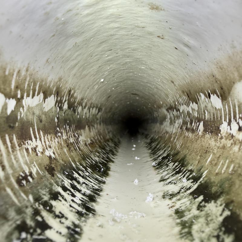 PVC drainage pipe interior with cracks and residue buildup