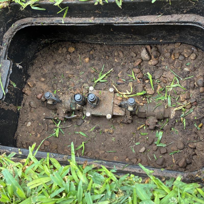 Sprinkler valve manifold in ground box with grass