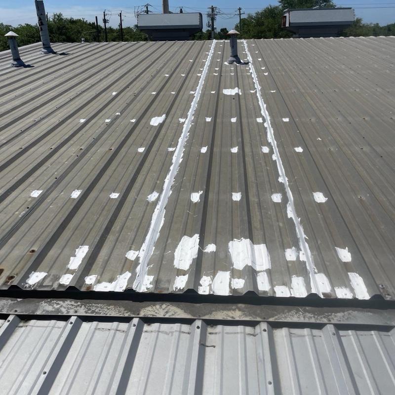 Metal roof sealant applied on panel laps and fasteners