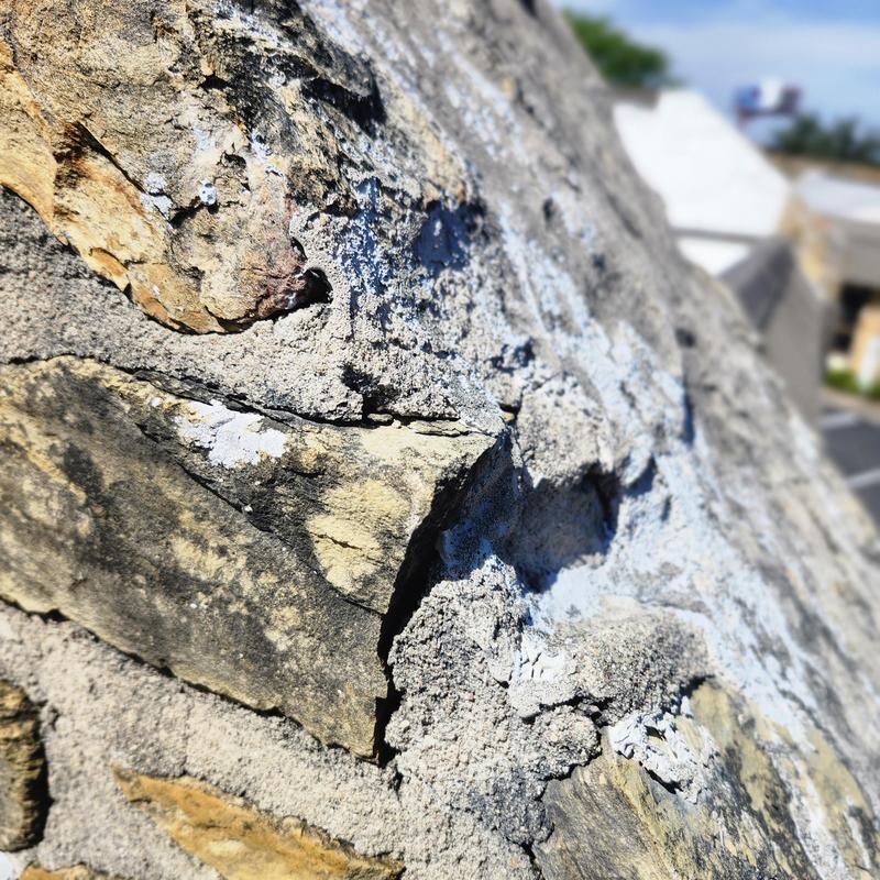 Sandstone wall cracks with visible erosion and damage Sandstone wall cracks with visible erosion and damage