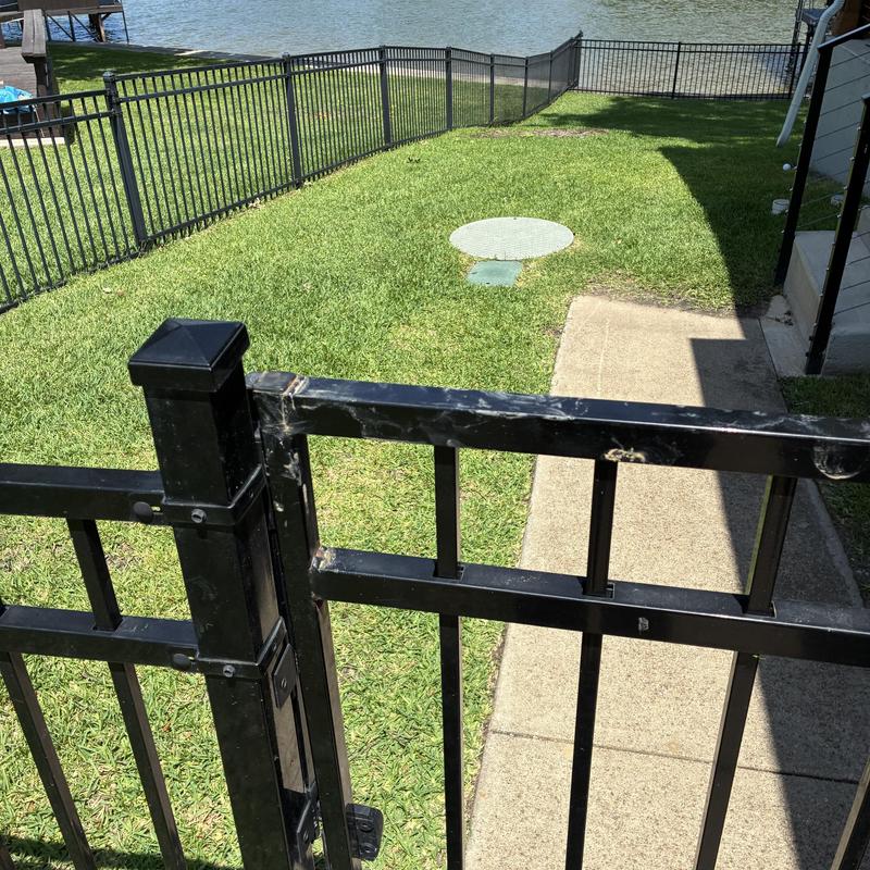 Sewer cleanout cap in grassy yard by lake Sewer cleanout cap in grassy yard by lake