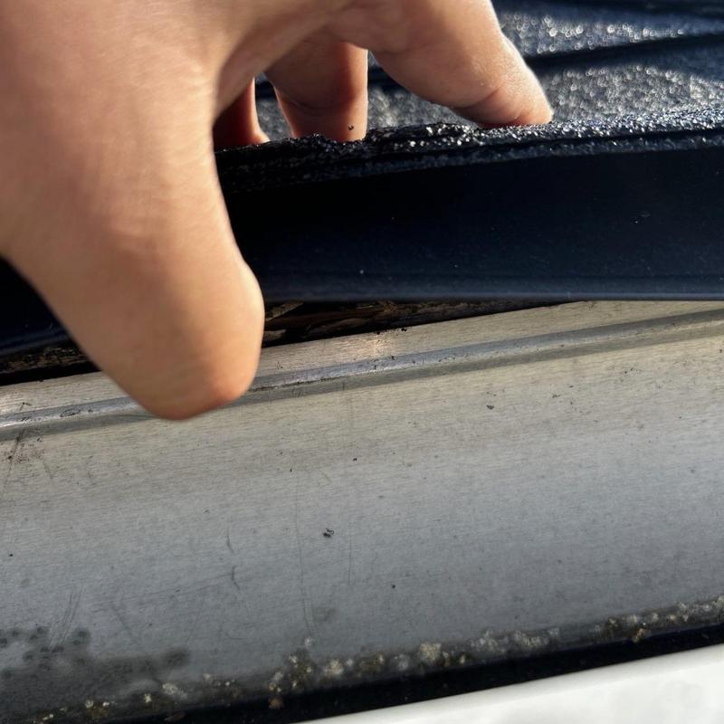 Roof drip edge lifted to show fascia damage