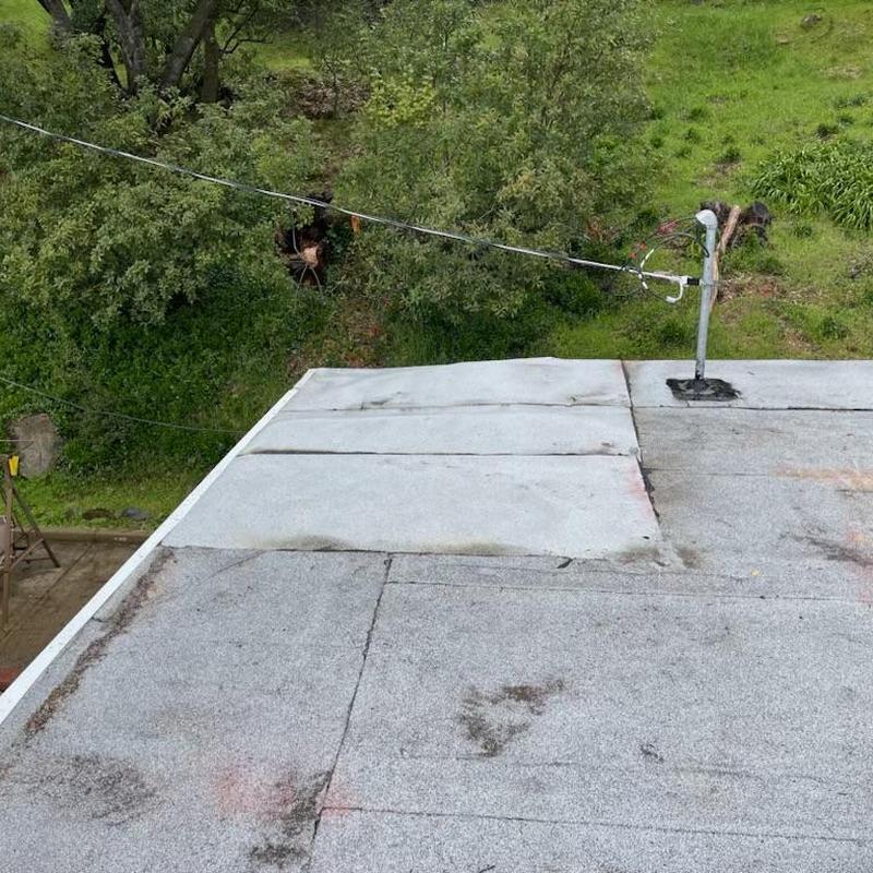 Flat roof patching with electrical conduit in Sonora CA