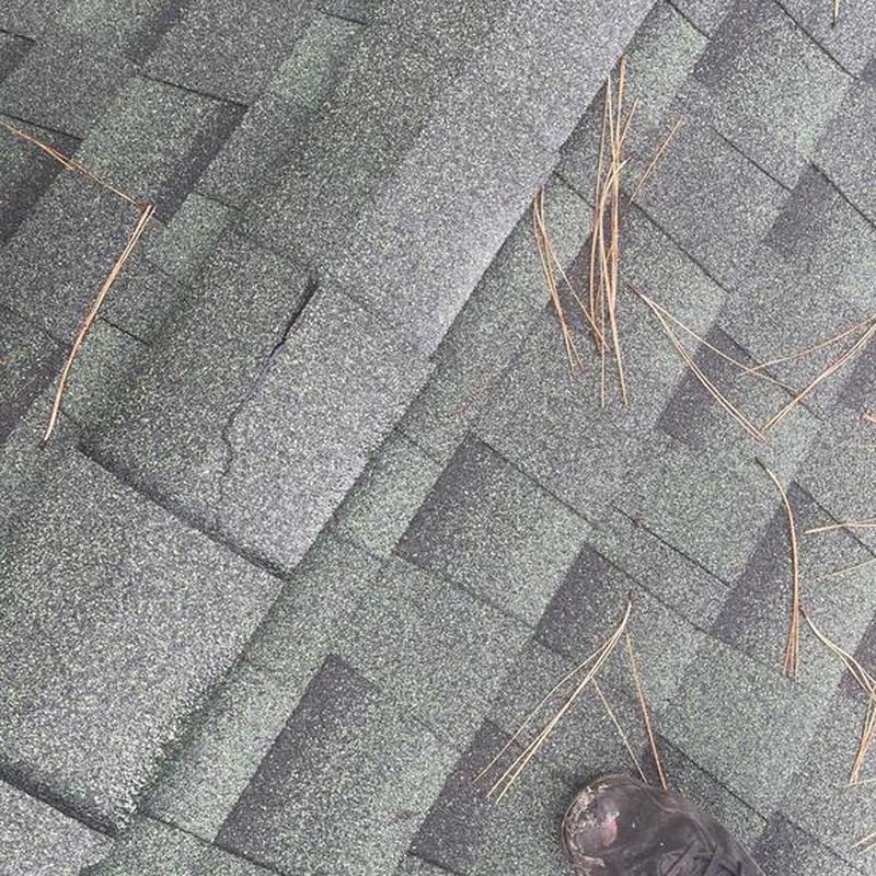 Asphalt shingle roof with ridge caps and pipe flashing