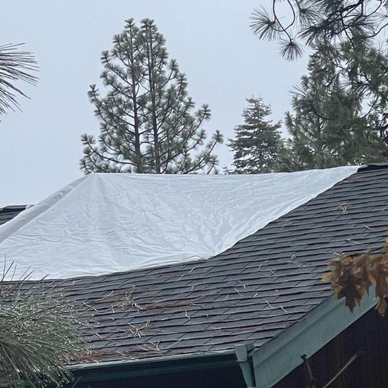 Cabin roof with tarp covering damaged area in Arnold, CA