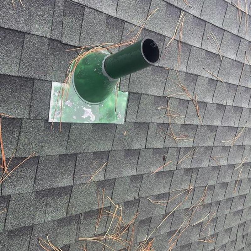 Pipe flashing on asphalt shingle roof with pine needles