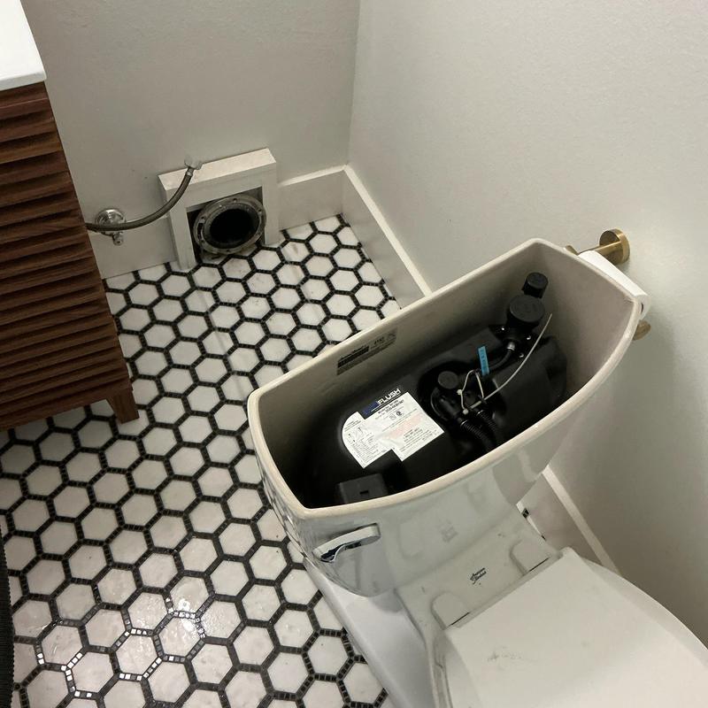 Toilet tank installation with hex tile flooring