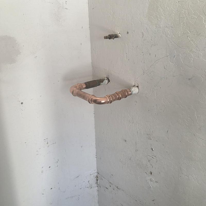 Copper water softener loop piping installation on wall Copper water softener loop piping installation on wall