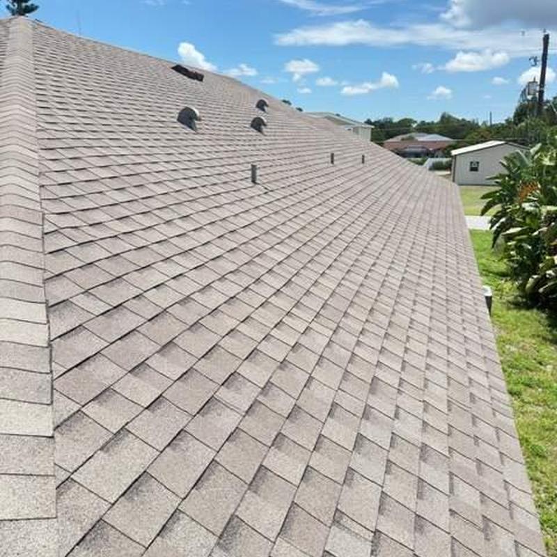 Shingle roof surface with vents under clear sky Shingle roof surface with vents under clear sky