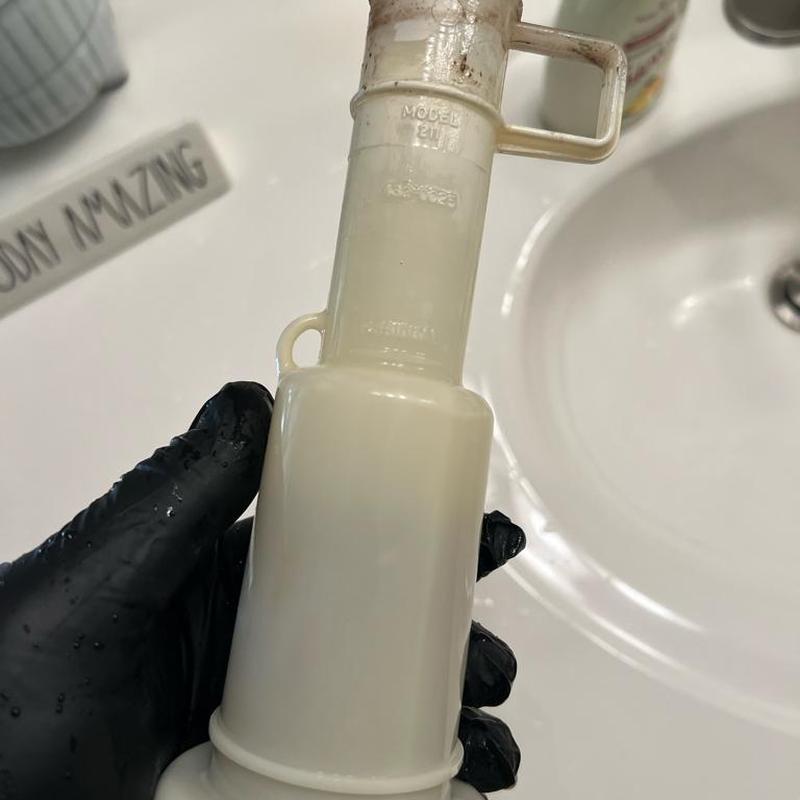 Mansfield flush valve kit held by gloved hand Mansfield flush valve kit held by gloved hand