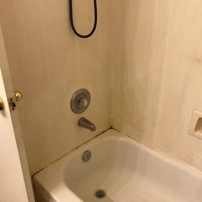 Bathtub and shower plumbing fixtures with wall stains Bathtub and shower plumbing fixtures with wall stains