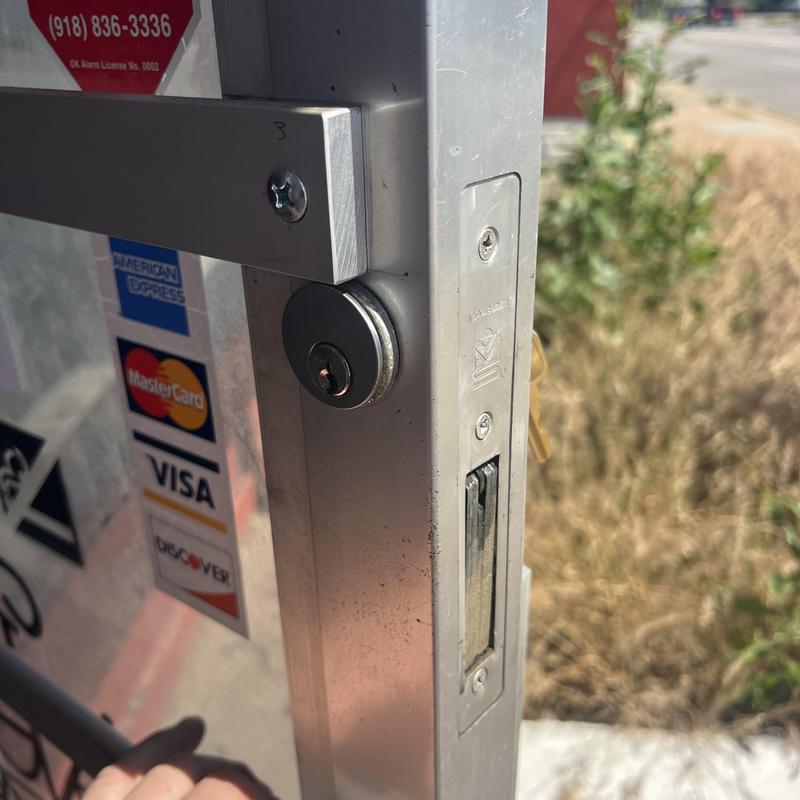 Metal commercial door locks rekeyed on business entrance
