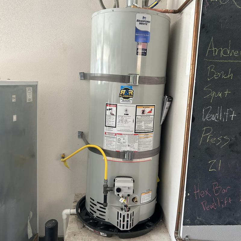 Bradford White water heater with gas line and catch pan
