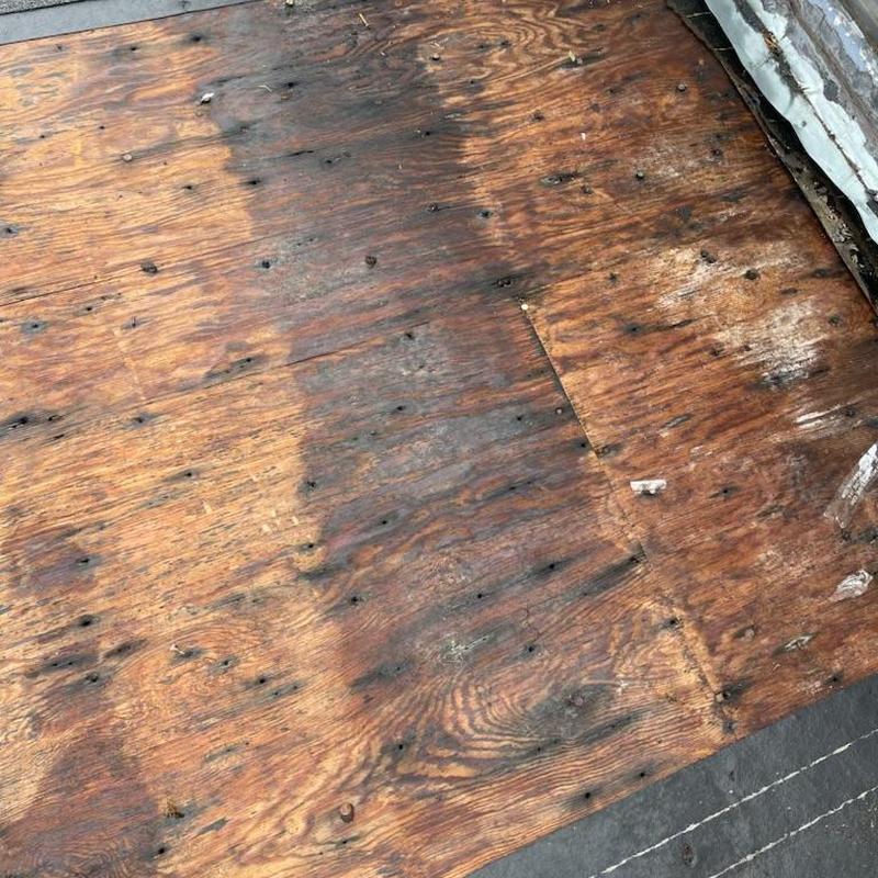 Plywood roof decking with dry rot damage and nails