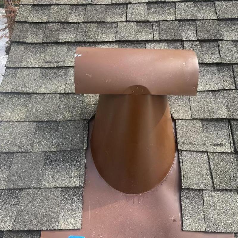 Roof vent with surrounding asphalt shingles on roof