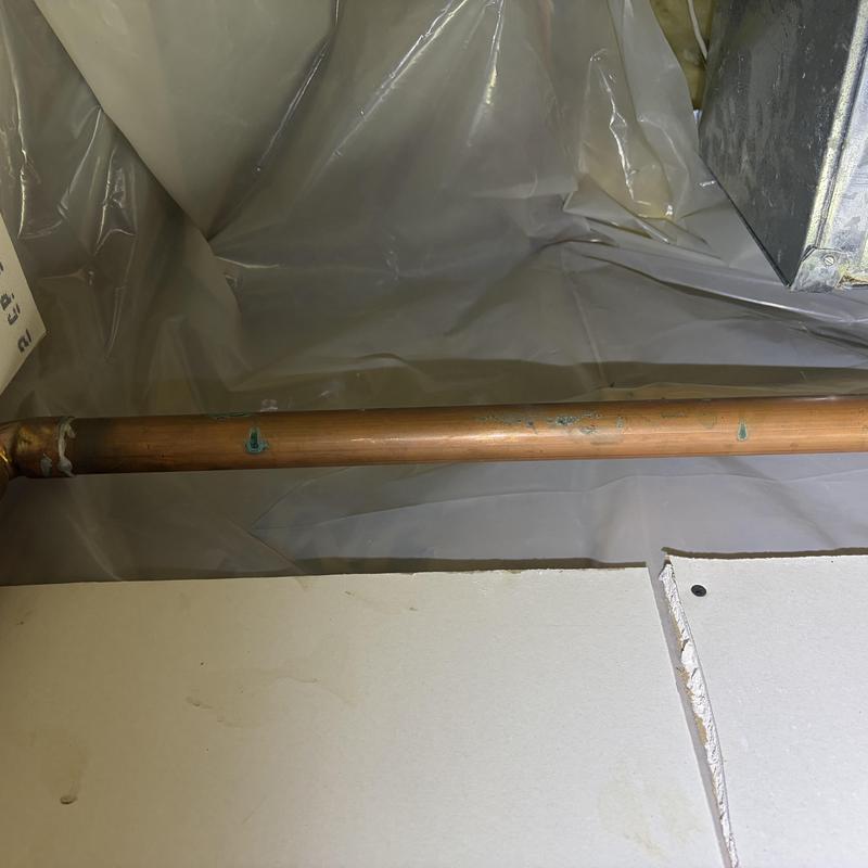 Copper water pipe with corrosion spots in crawl space Copper water pipe with corrosion spots in crawl space