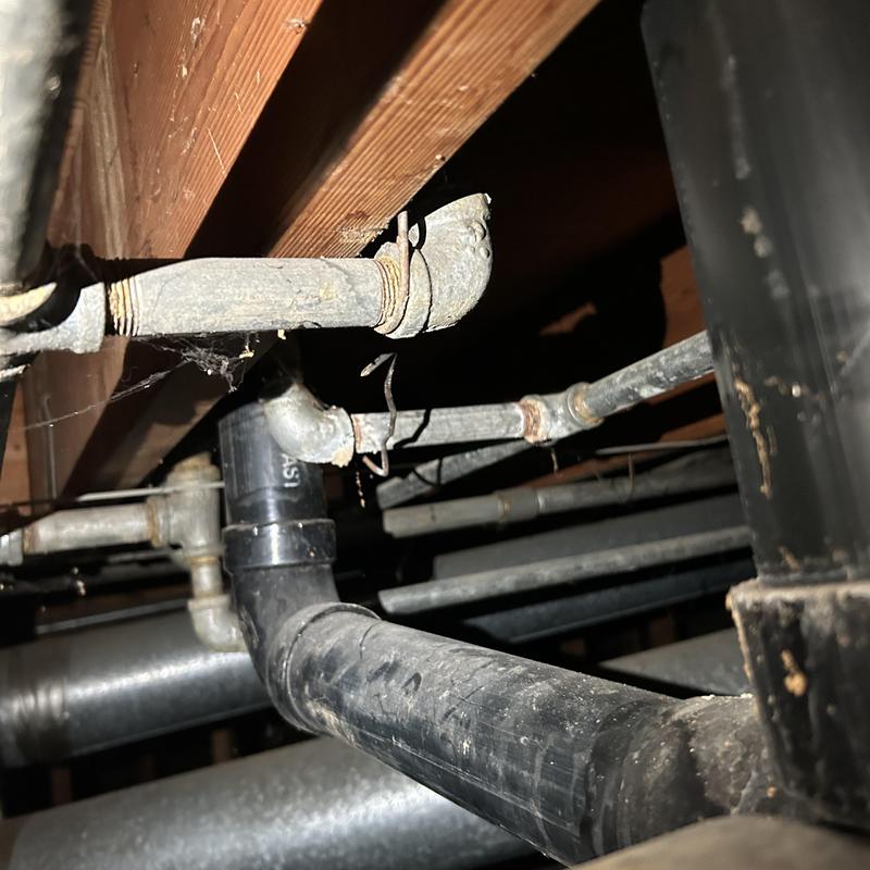 Galvanized water pipes with leak under wood floor joist Galvanized water pipes with leak under wood floor joist