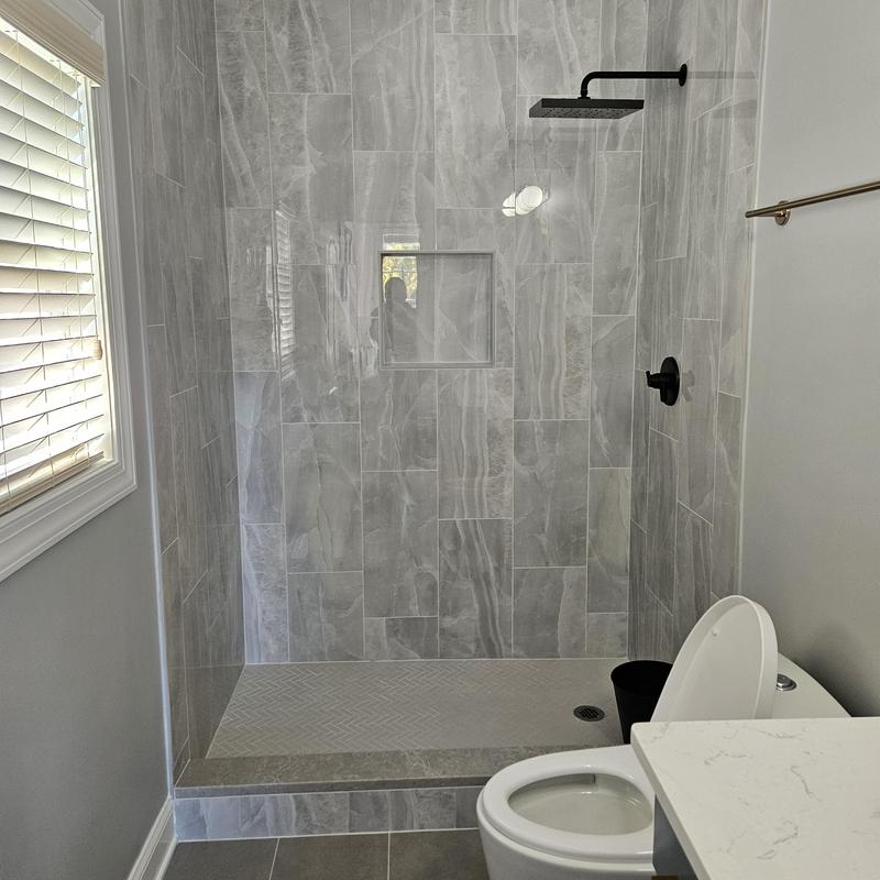Tile shower walls and black shower fixtures in bathroom Tile shower walls and black shower fixtures in bathroom