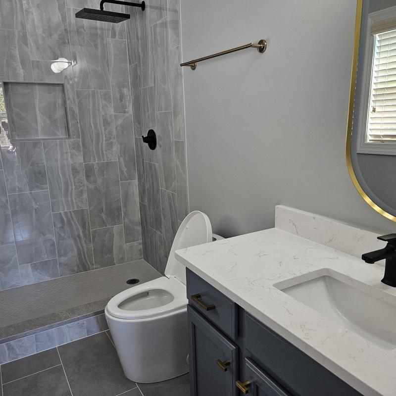 Shower system with black fixtures and tiled walls Shower system with black fixtures and tiled walls