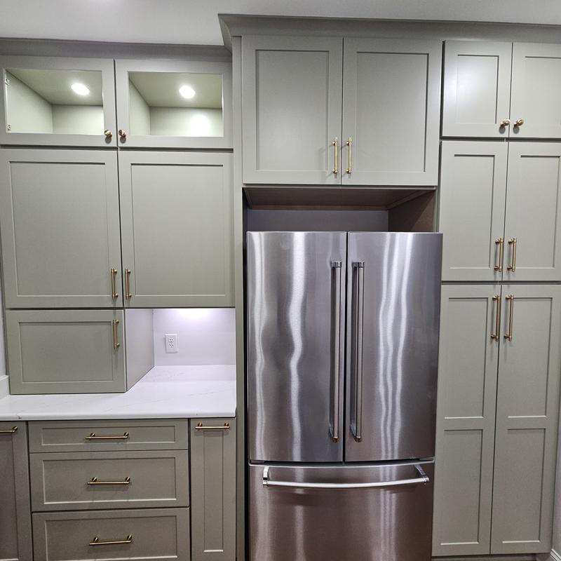 Stainless steel refrigerator with custom gray cabinetry Stainless steel refrigerator with custom gray cabinetry