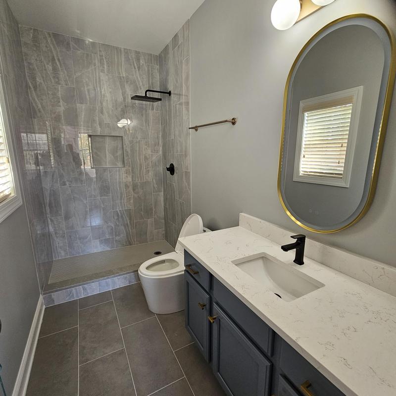 Wall tile shower with black fixtures and vanity Wall tile shower with black fixtures and vanity