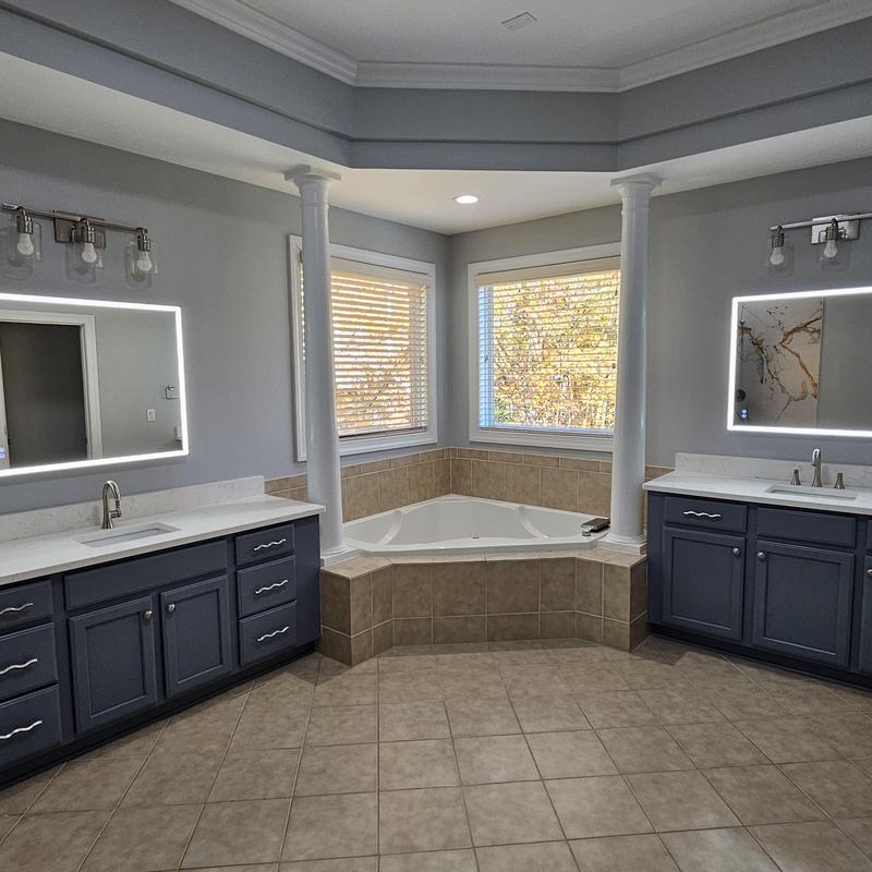 Corner bathtub with tile surround and dual vanities Corner bathtub with tile surround and dual vanities