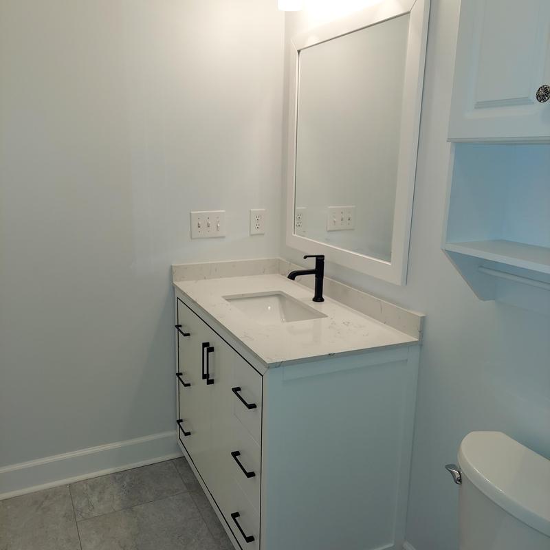 Bathroom vanity with black faucet and white countertop Bathroom vanity with black faucet and white countertop