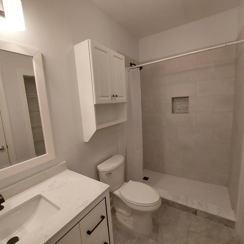 Shower tile walls and pan with toilet and vanity Shower tile walls and pan with toilet and vanity