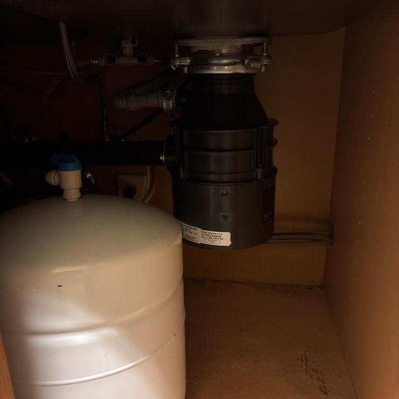 Kitchen garbage disposal installed under sink in cabinet Kitchen garbage disposal installed under sink in cabinet