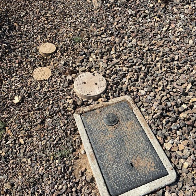 Zurn one-inch P.R.V. with tan access box in landscaping rock Zurn one-inch P.R.V. with tan access box in landscaping rock