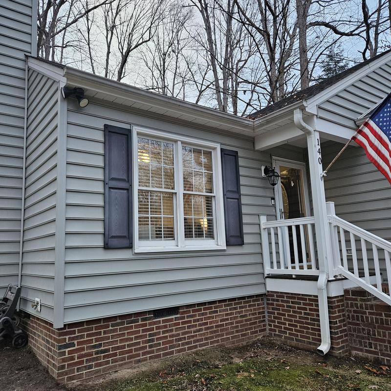 Vinyl siding and brick foundation on residential home Vinyl siding and brick foundation on residential home