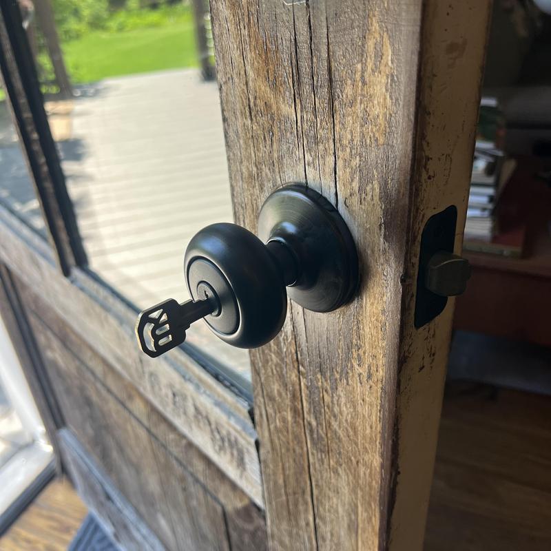 Kwikset door knob with key in rustic wooden door