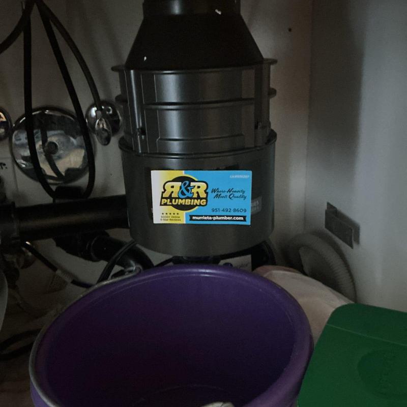 Garbage disposal unit under sink with drain piping