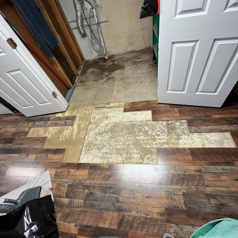 Vinyl plank flooring partially removed for repairs