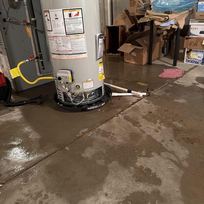 Water heater base with drain pan installation in basement Water heater base with drain pan installation in basement