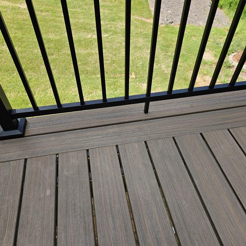 Composite deck flooring with black metal railing Composite deck flooring with black metal railing