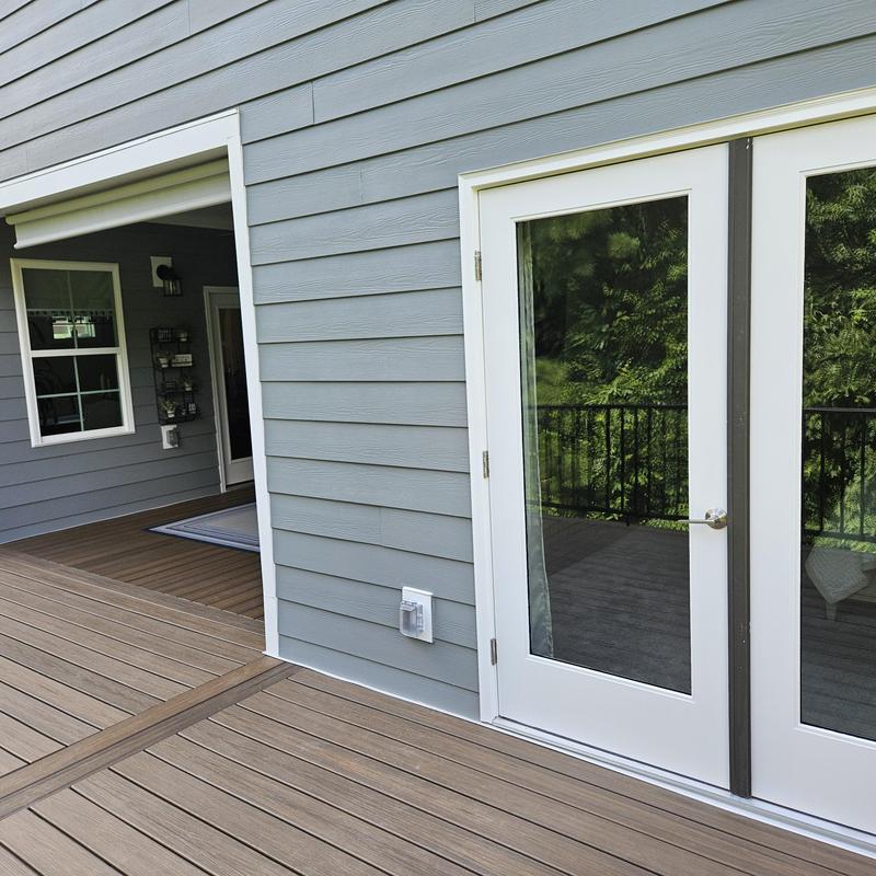 Composite deck with glass French doors and gray siding Composite deck with glass French doors and gray siding