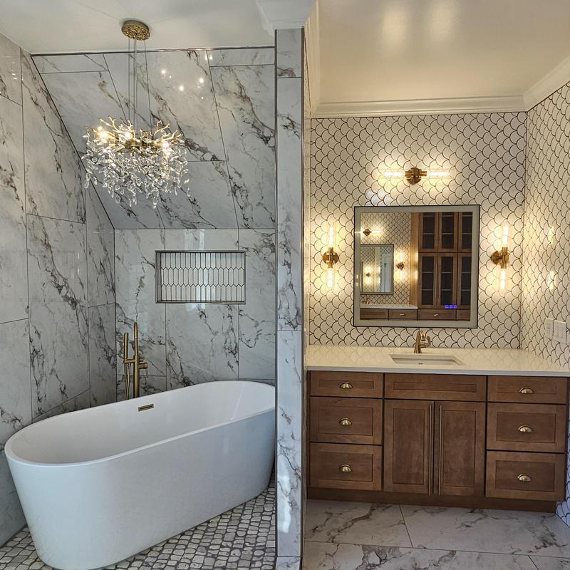 Freestanding bathtub and vanity with marble tile walls Freestanding bathtub and vanity with marble tile walls