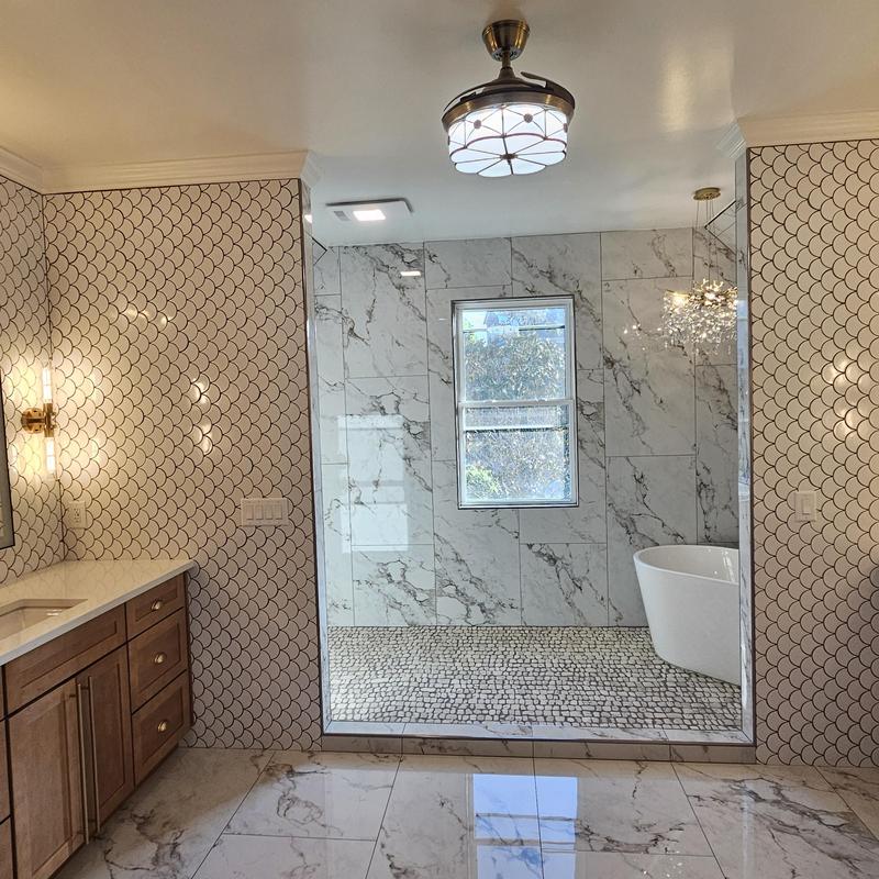 Marble tiled shower enclosure with window and tub Marble tiled shower enclosure with window and tub