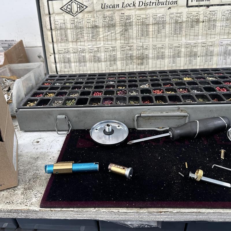 Lock cylinder disassembled with pins and screwdriver