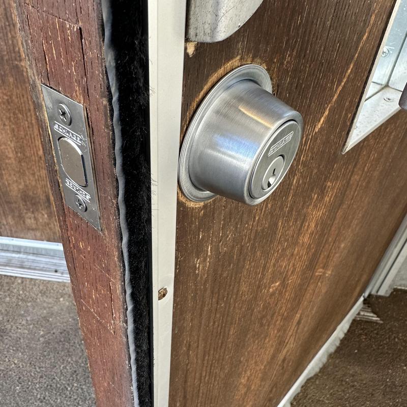 Deadbolt lock on thick wood door with keyhole