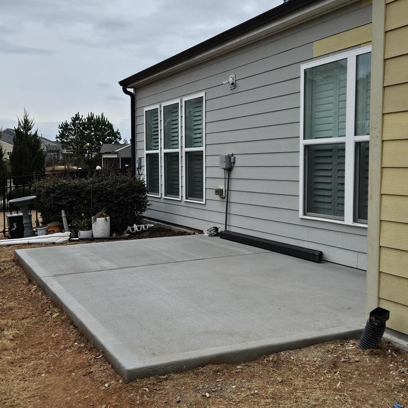 Concrete patio slab installation near home siding Concrete patio slab installation near home siding