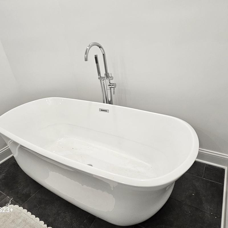 Freestanding bathtub with chrome floor-mounted faucet Freestanding bathtub with chrome floor-mounted faucet