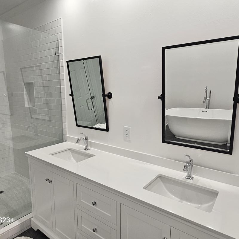 Bathroom double vanity with sinks and black framed mirrors Bathroom double vanity with sinks and black framed mirrors