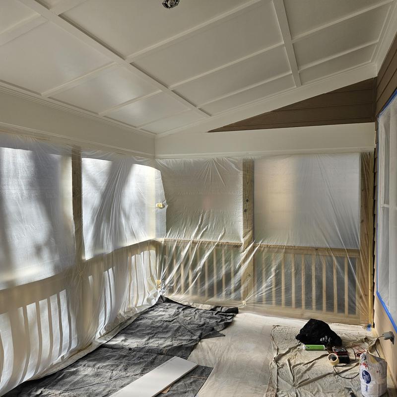 Deck railing with protective plastic sheeting and drop cloths Deck railing with protective plastic sheeting and drop cloths