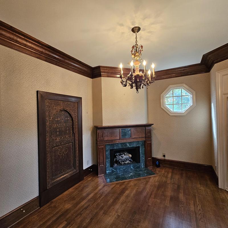Wooden fireplace with marble surround and chandelier Wooden fireplace with marble surround and chandelier