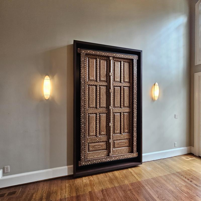 Decorative wooden door installation in framed wall niche Decorative wooden door installation in framed wall niche