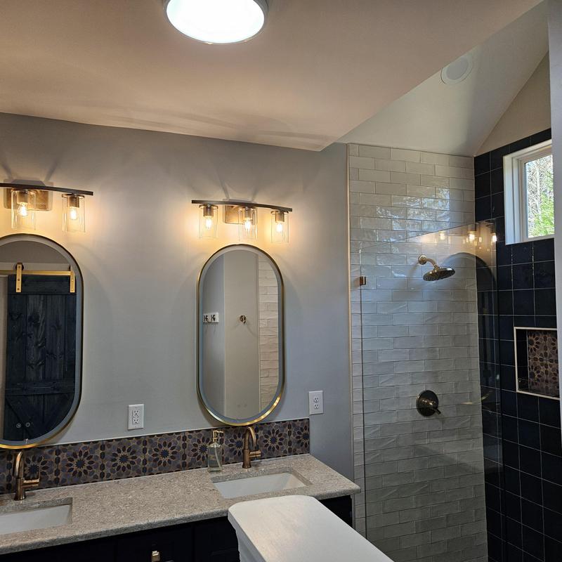 Bathroom vanity with dual mirrors and lighting fixtures Bathroom vanity with dual mirrors and lighting fixtures