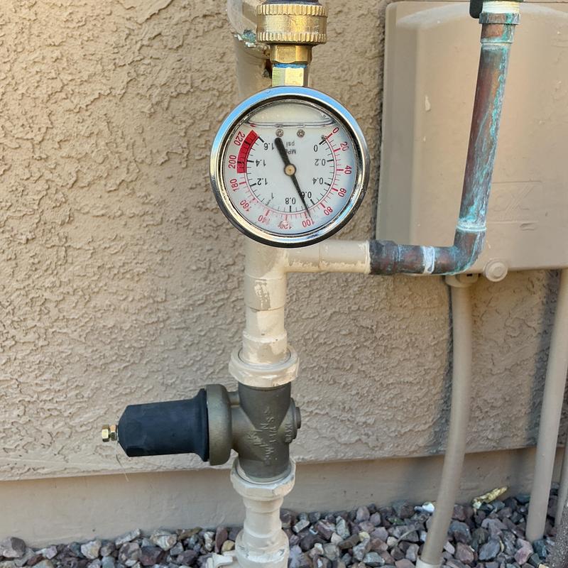 Pressure regulator valve with gauge on plumbing system