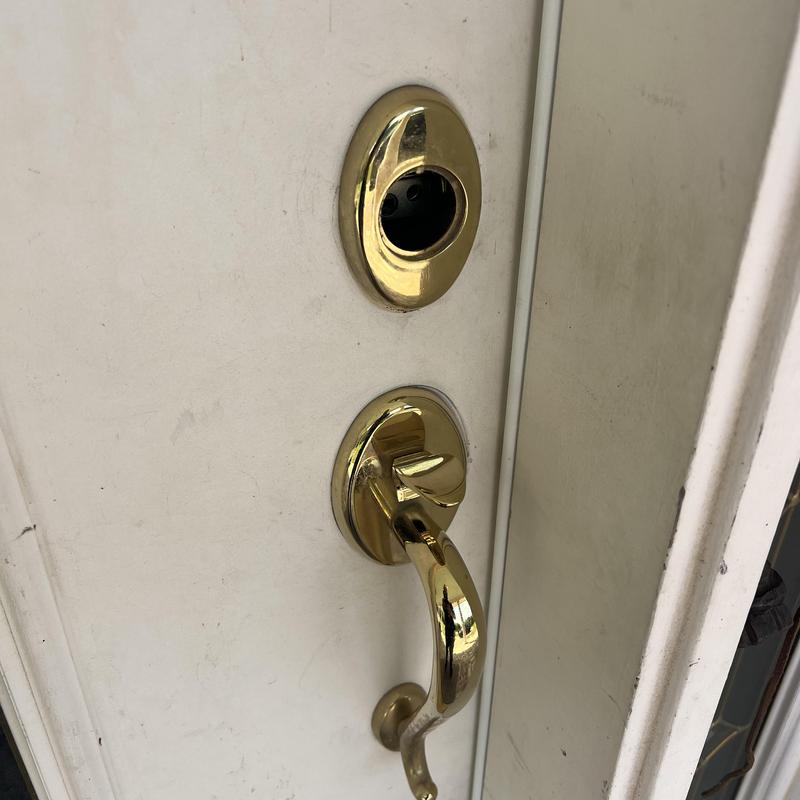 Front door lock housing removed for rekeying
